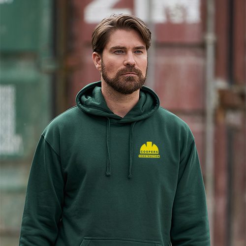 Man wearing a dark green hoodie with logo